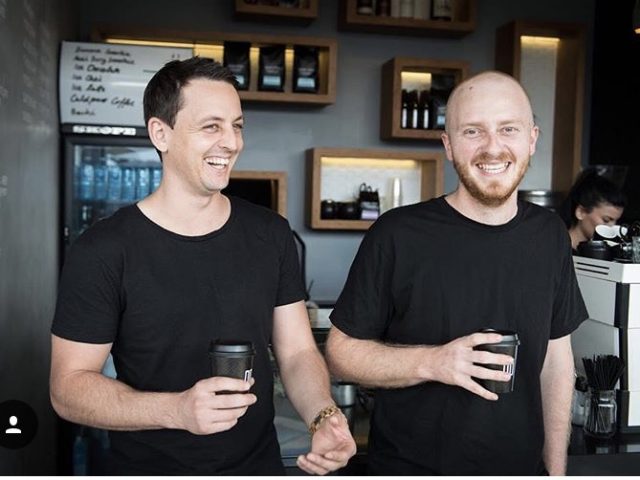 Andrew Foster and Harrison Black sipping coffee