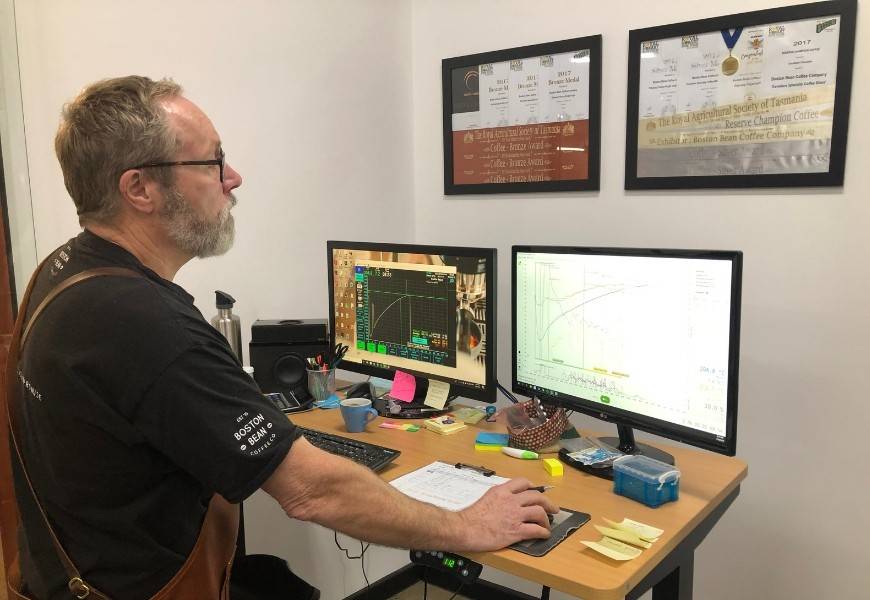 Richard from Boston Bean checks the monitor of the Loring S15 falcon smart roasting machine