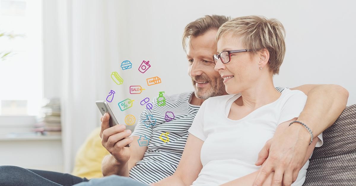 Older couple looking at rewards, deals, and discounts on their phone