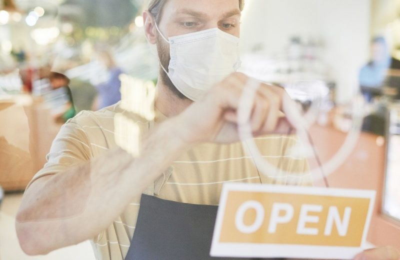 Retail Worker With Open Sign